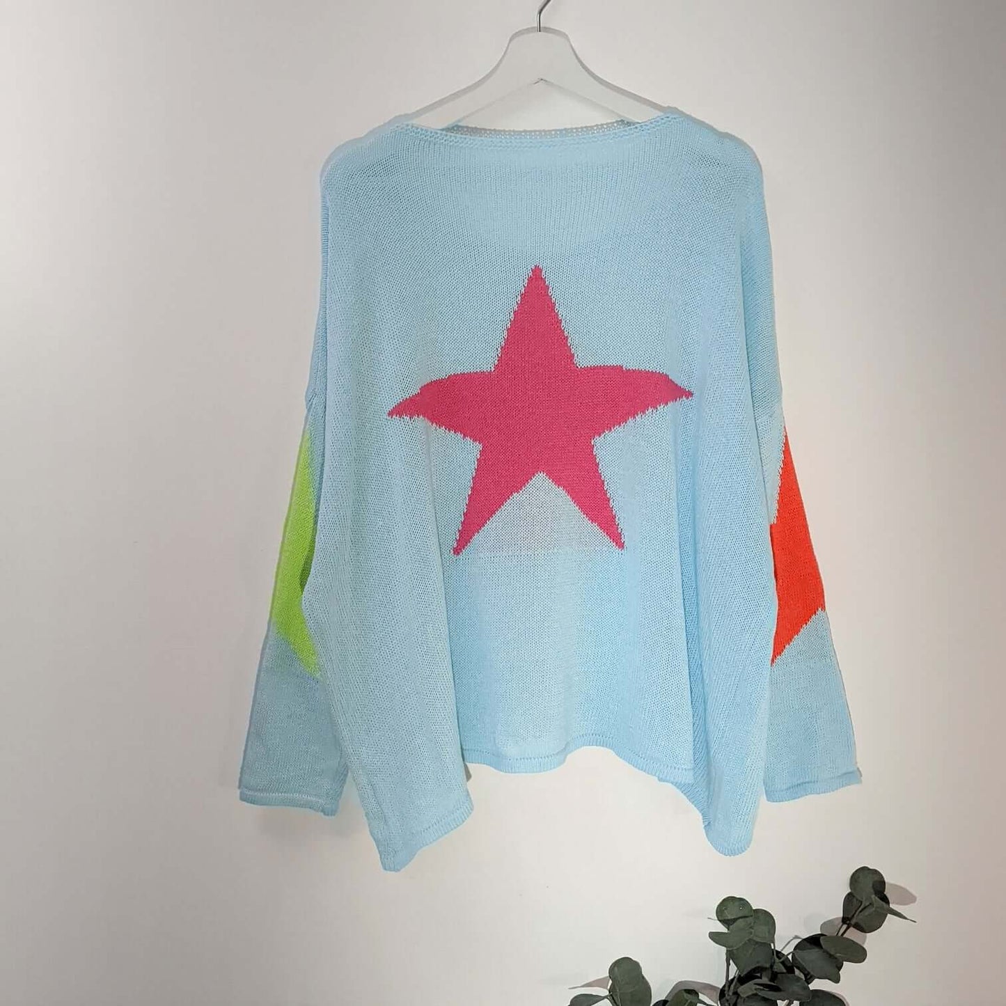 Slight hi-lo jumper with bright stars on back and elbows