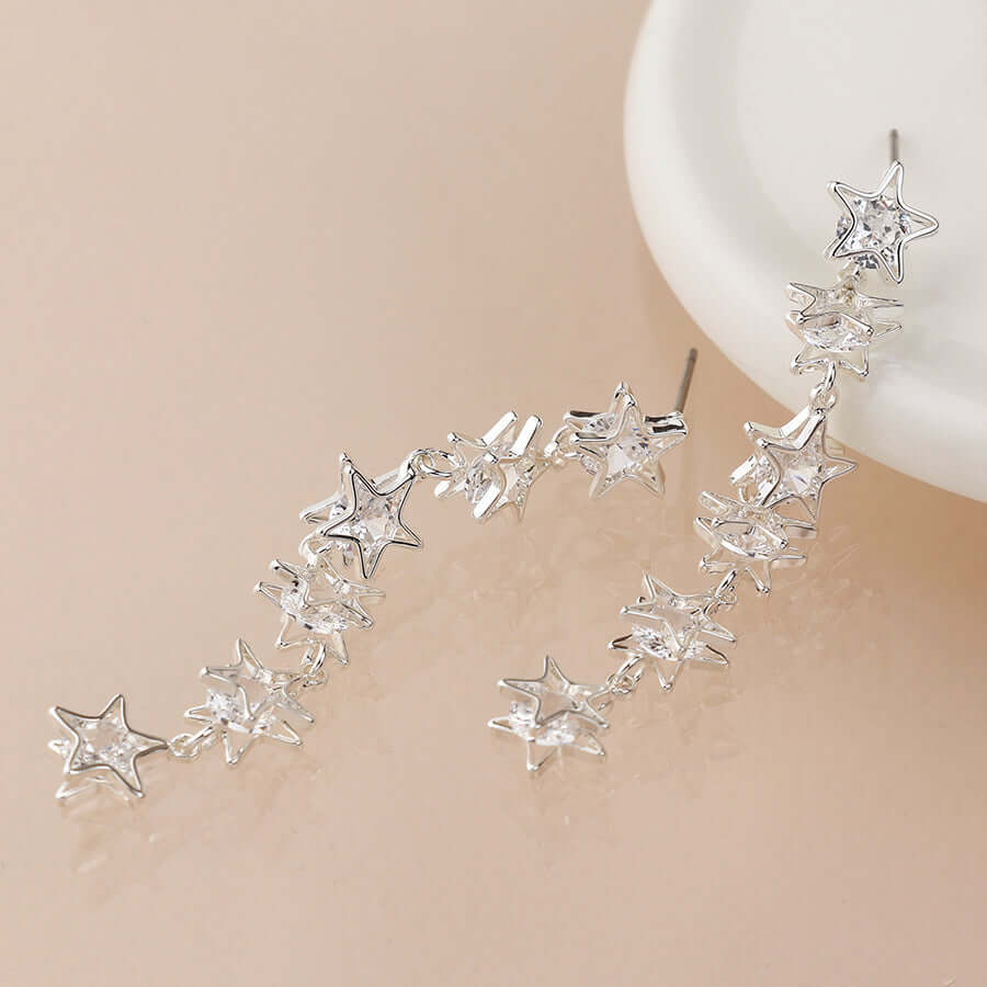POM - Silver plated crystal centred multi star drop earrings