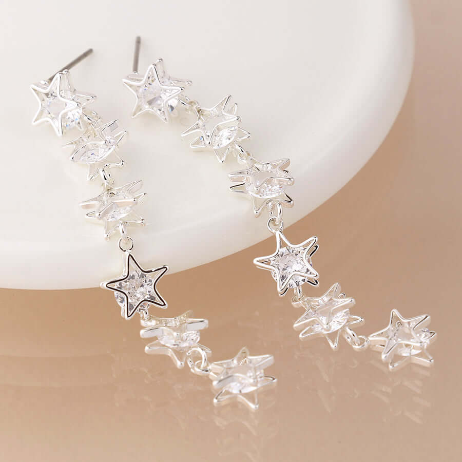 POM - Silver plated crystal centred multi star drop earrings