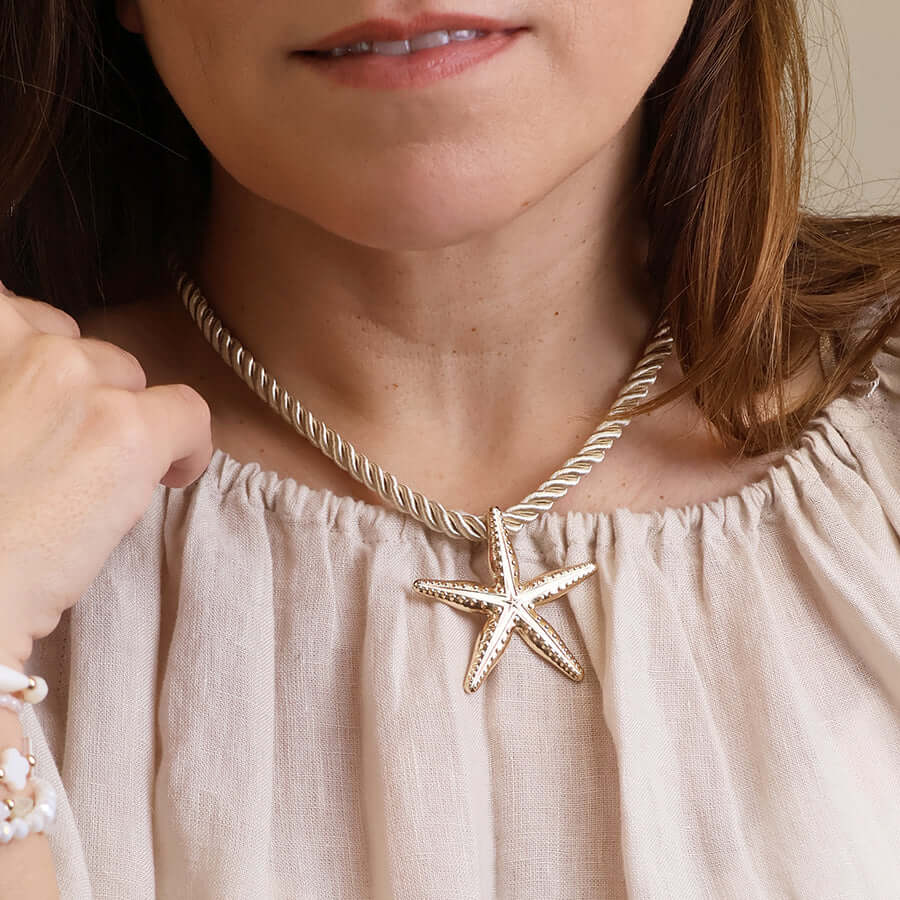 POM925 - Golden starfish off white cord necklace