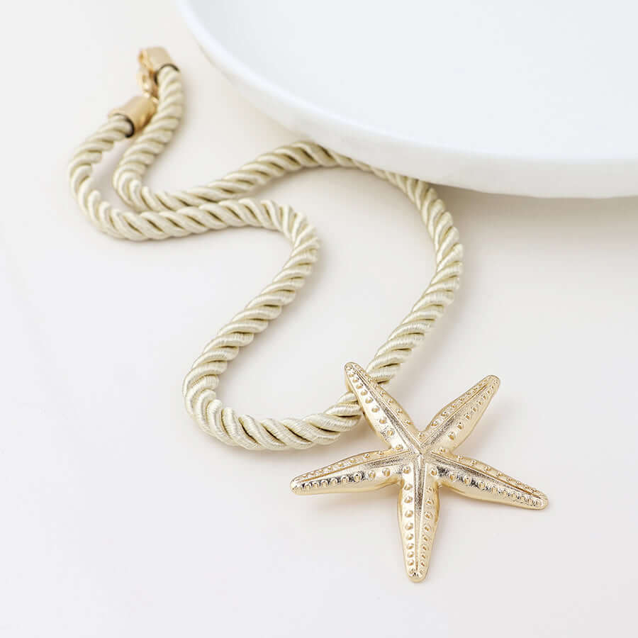POM925 - Golden starfish off white cord necklace