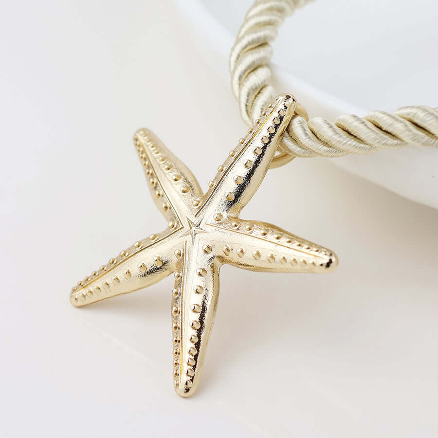 POM925 - Golden starfish off white cord necklace