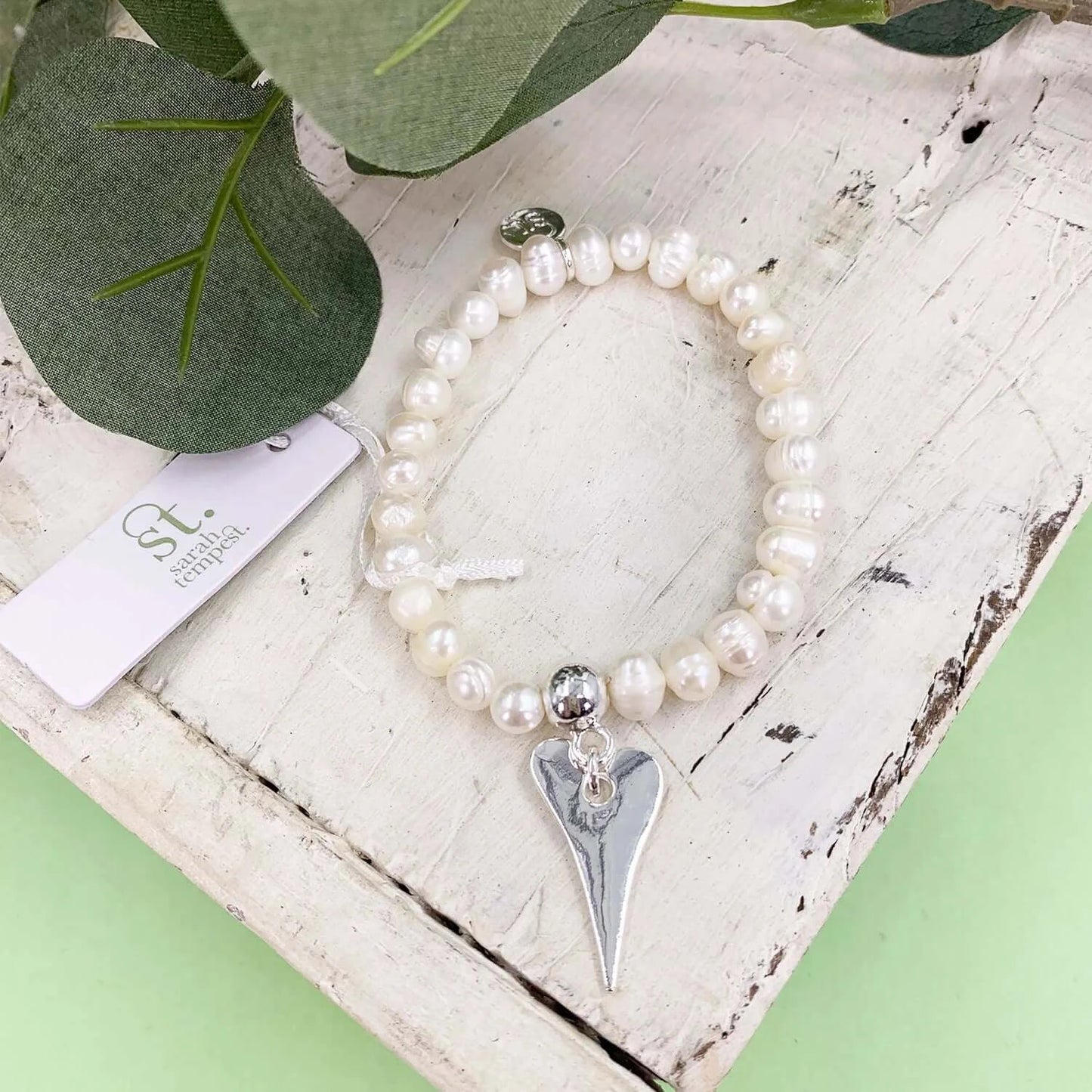 Elongated heart charm on stretchy pearl bracelet